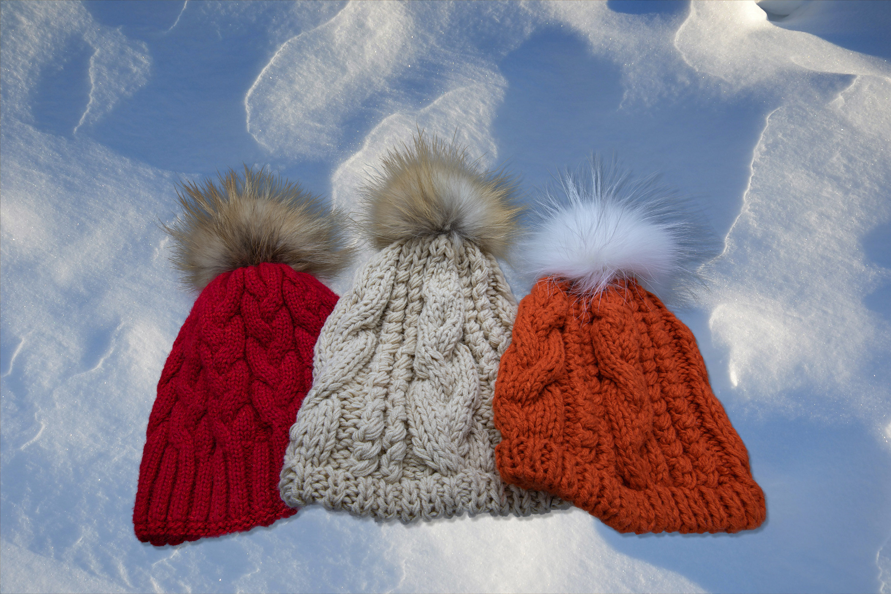 wool and cashmere cableknit hats with fur pom pom product photography